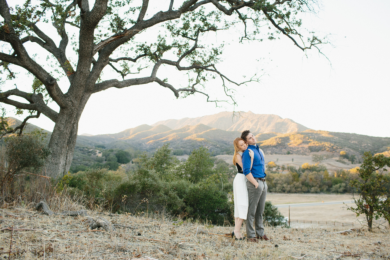 A sweet photo of the couple with hills in the background. 