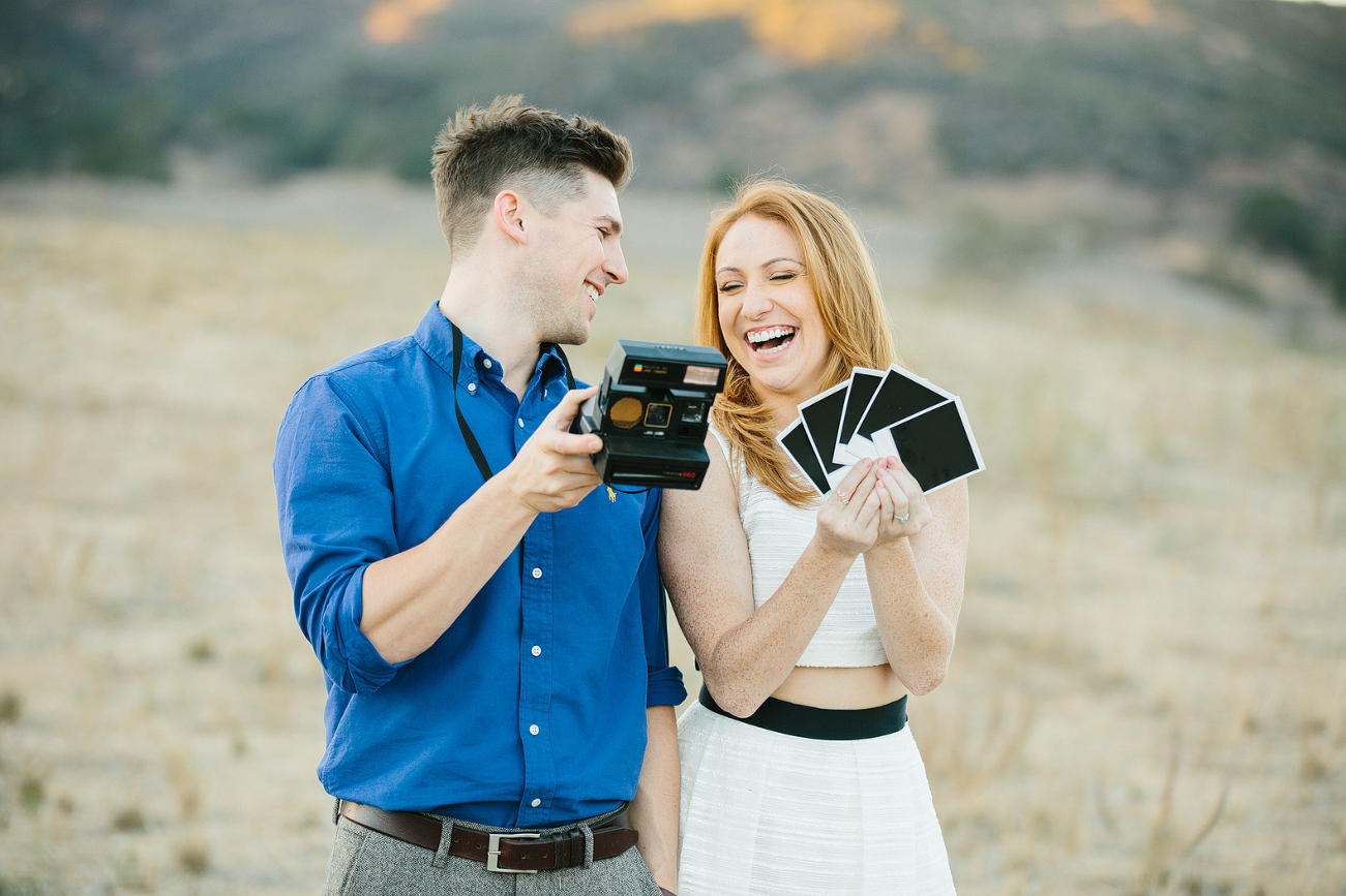 A cute photo of the couple use the Polaroid camera. 