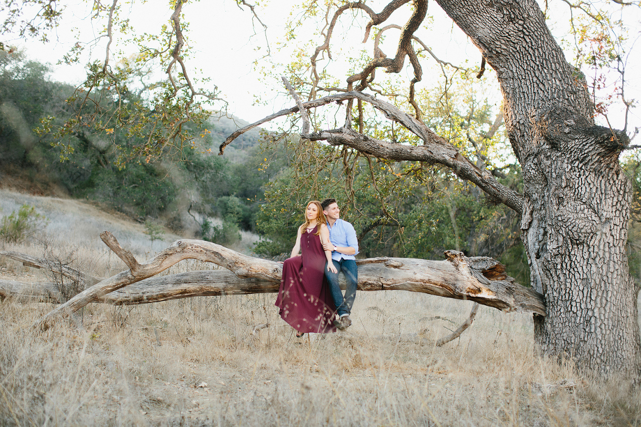 Mallauri and Curt sitting on a tree branch. 