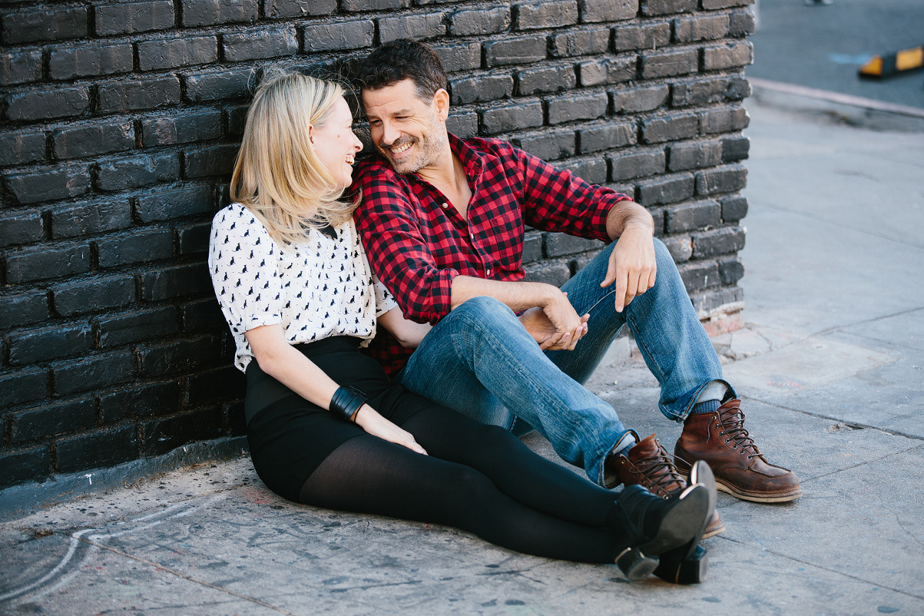 Hayley and David sitting together on the sidewalk. 