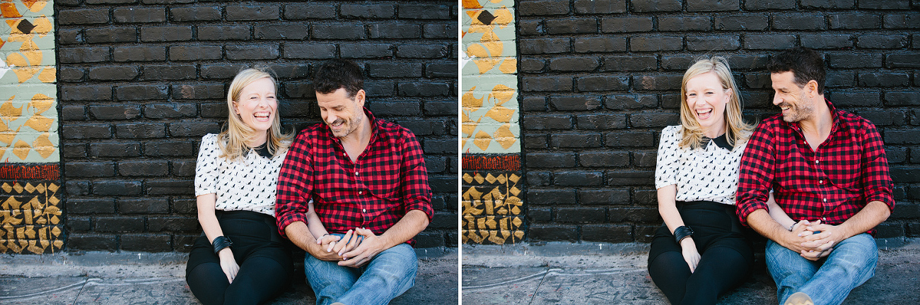 Hayley and David sitting in front of a black brick wall. 