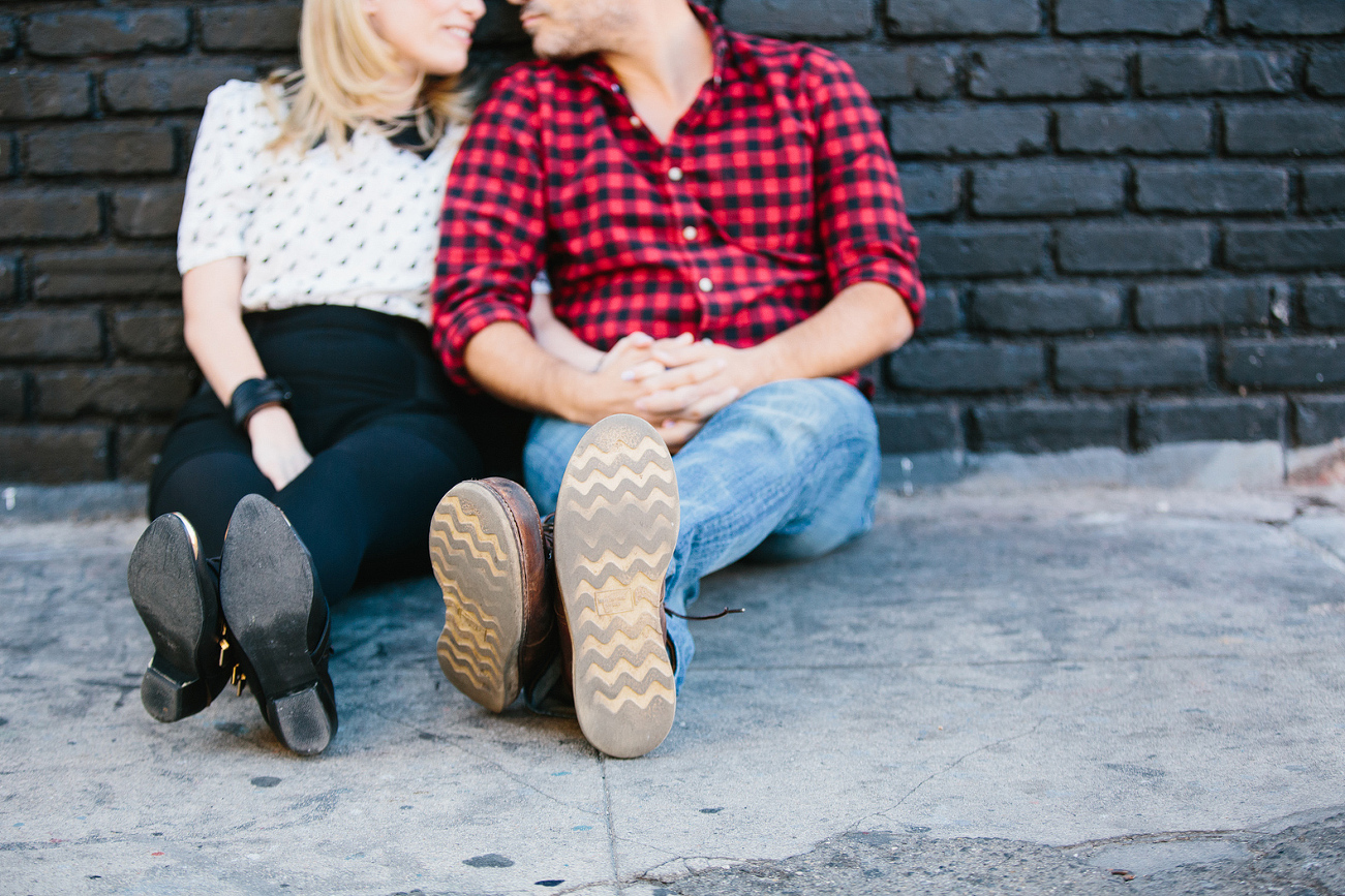 A cool shot of the couple sitting in the Arts District. 