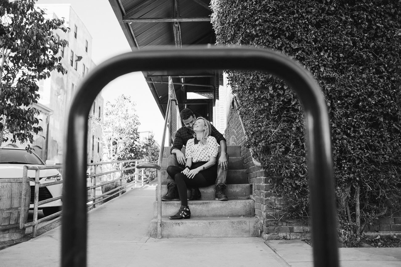 A black and white photo of the ocuple sitting on steps. 