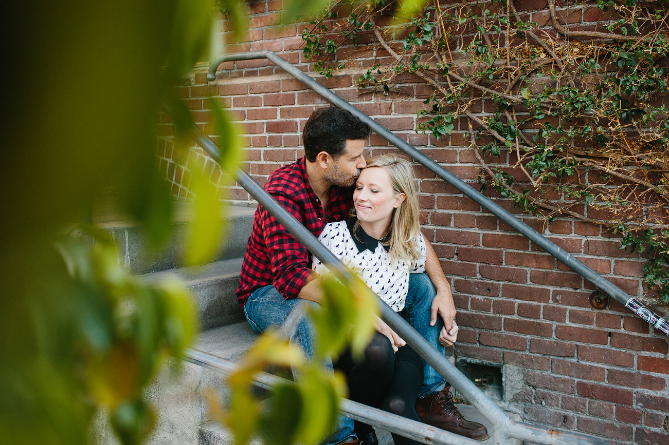 A photo shot through the trees of Hayley and David. 