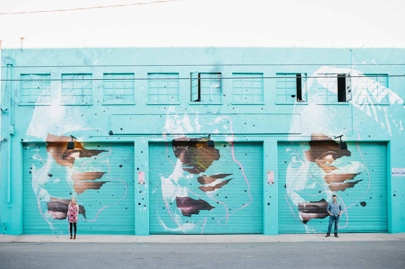 Hayley and David outside a teal building. 