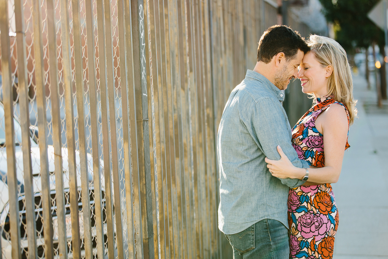 Hayley and David hugging by a fence. 