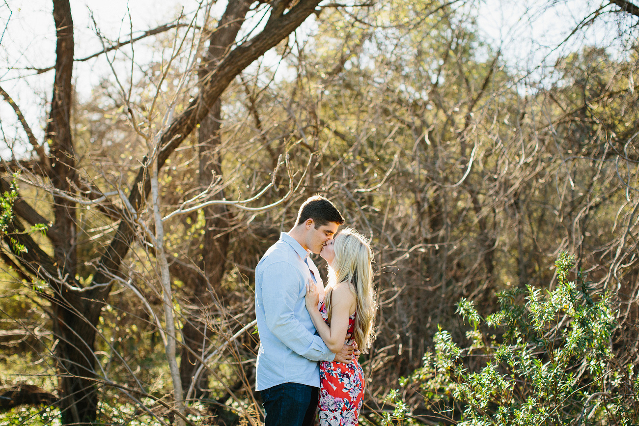 Britt and Steve in front of small trees. 