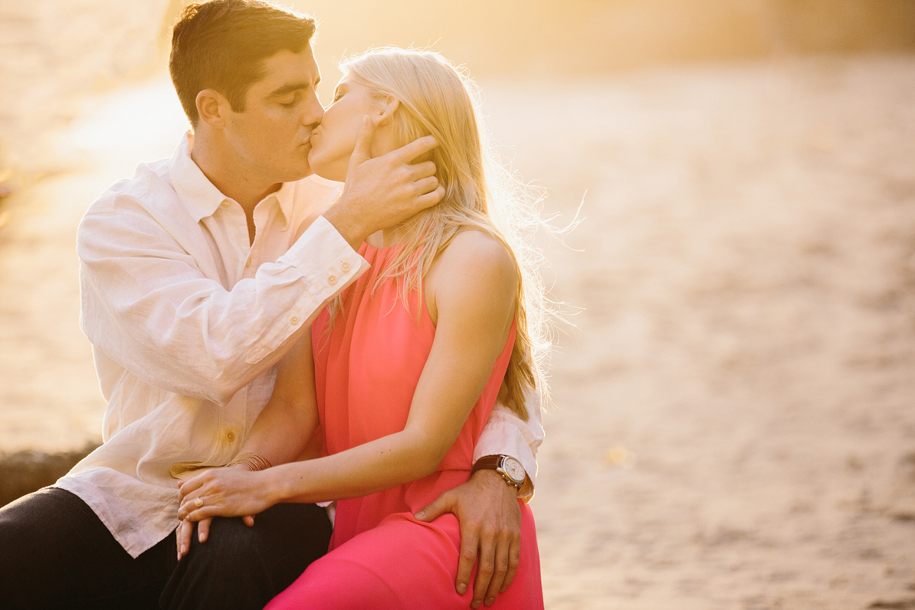 The couple sitting on a rock. 