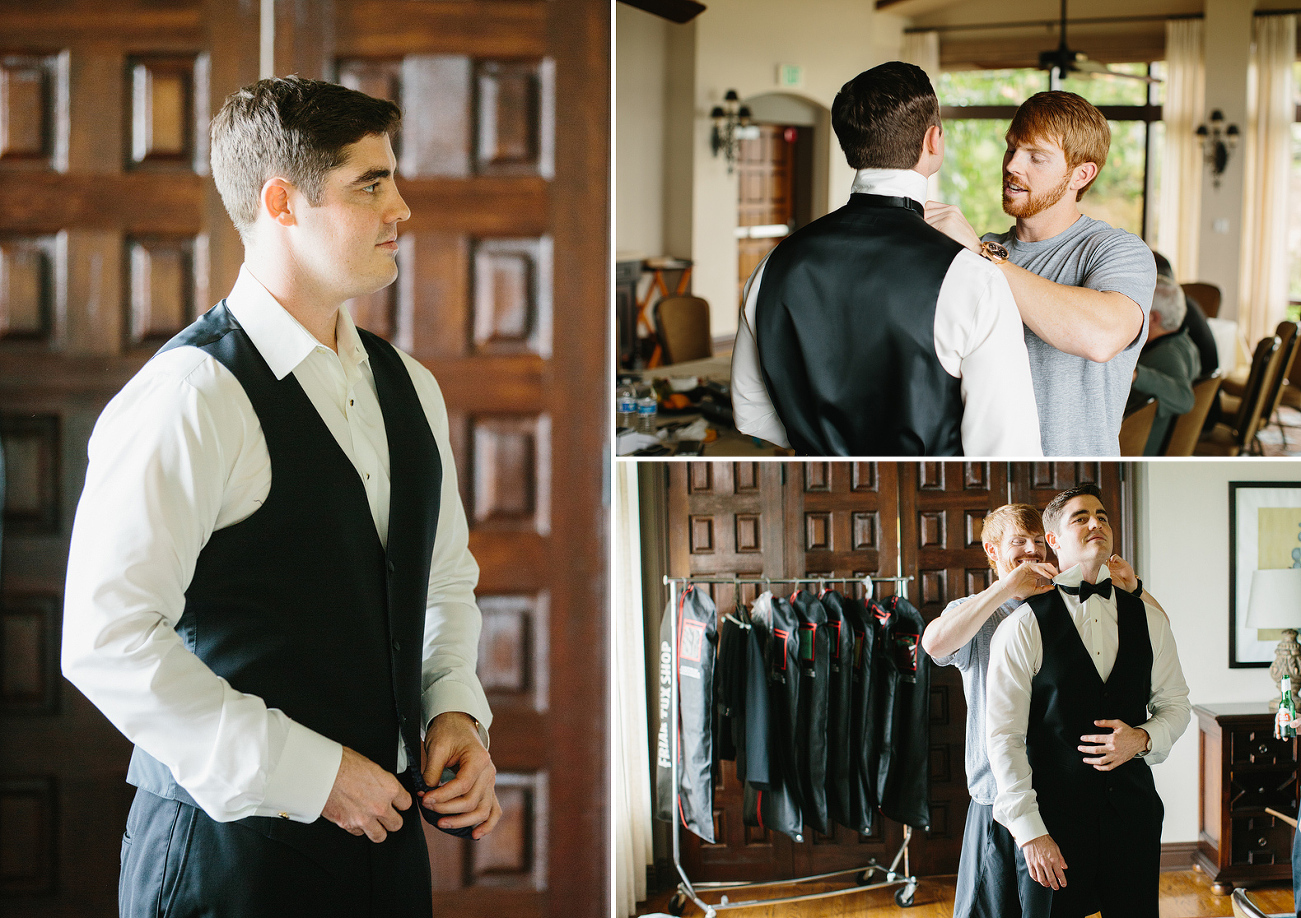 A groomsmen helping Steve put on his bowtie. 