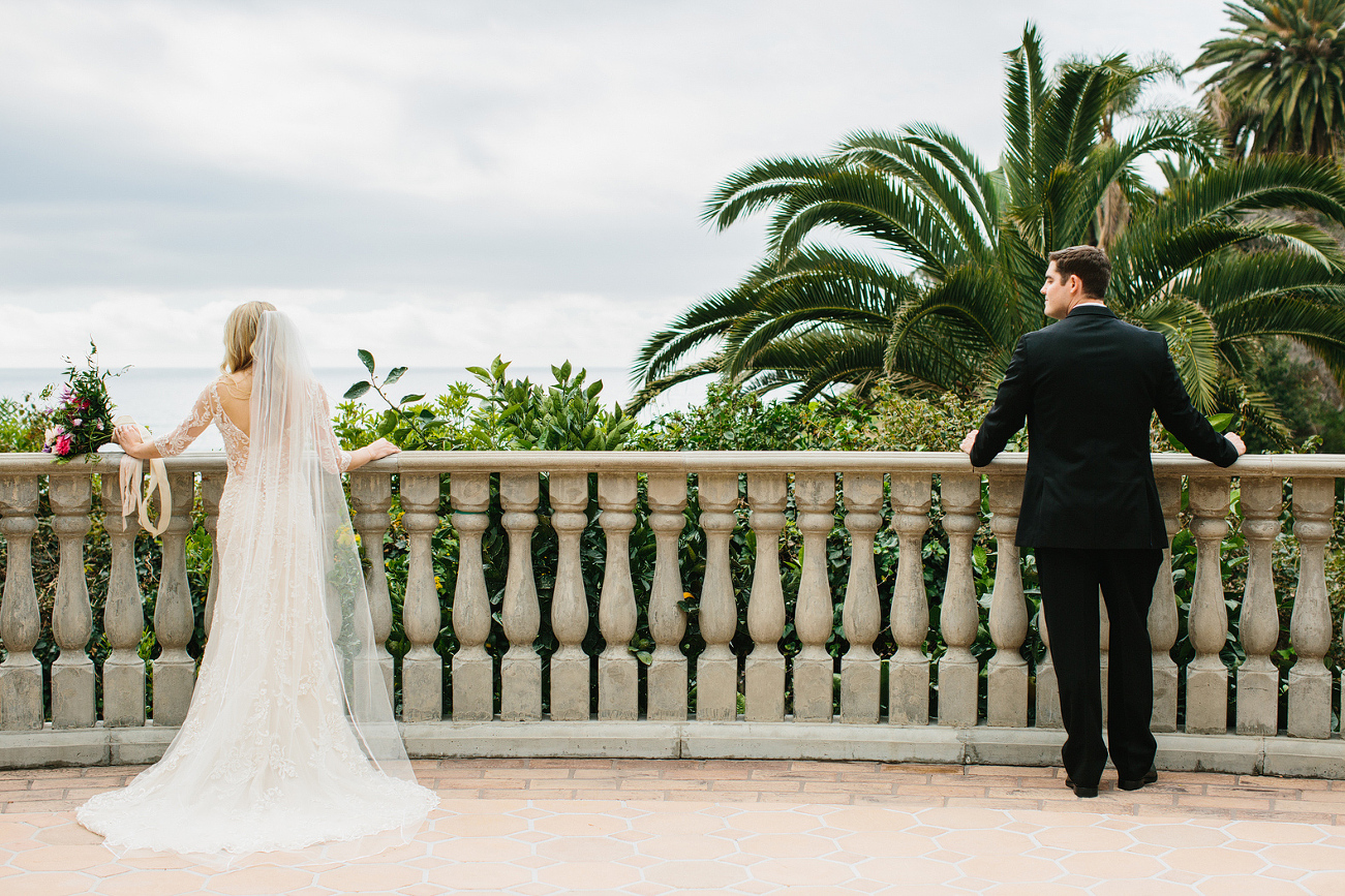 The bride and groom looking out on the balcony. 