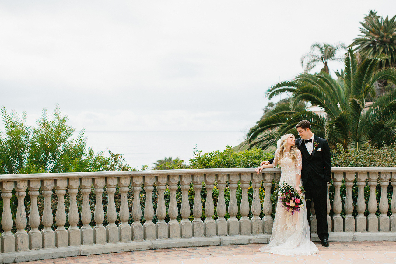 Britt and Steve together on the balcony with the ocean in the background. 