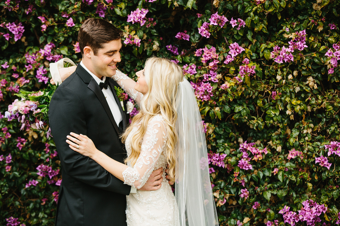 The couple in front of gorgeous greenery. 