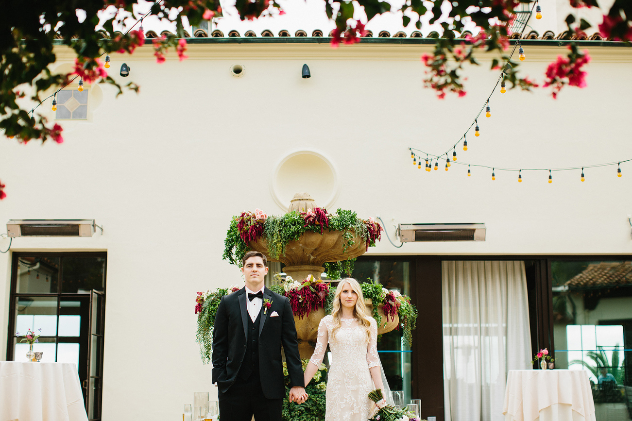 The bride and groom in front of the fountain. 