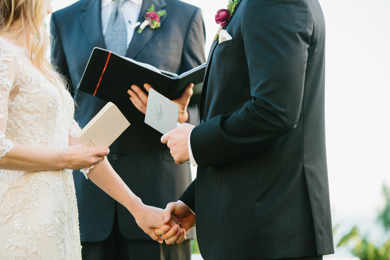 The couple reading their personal vows. 