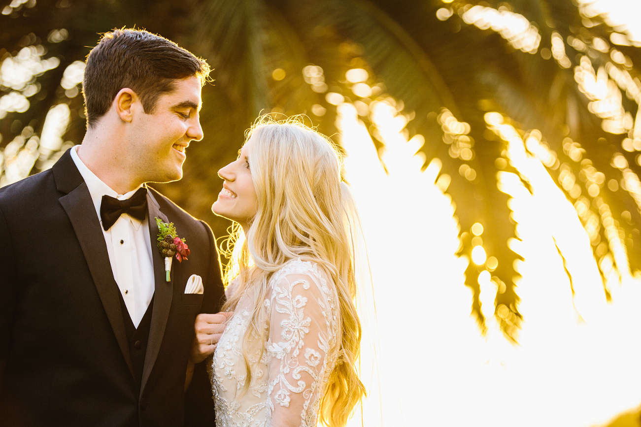 A bright golden photo of the couple looking at each other. 