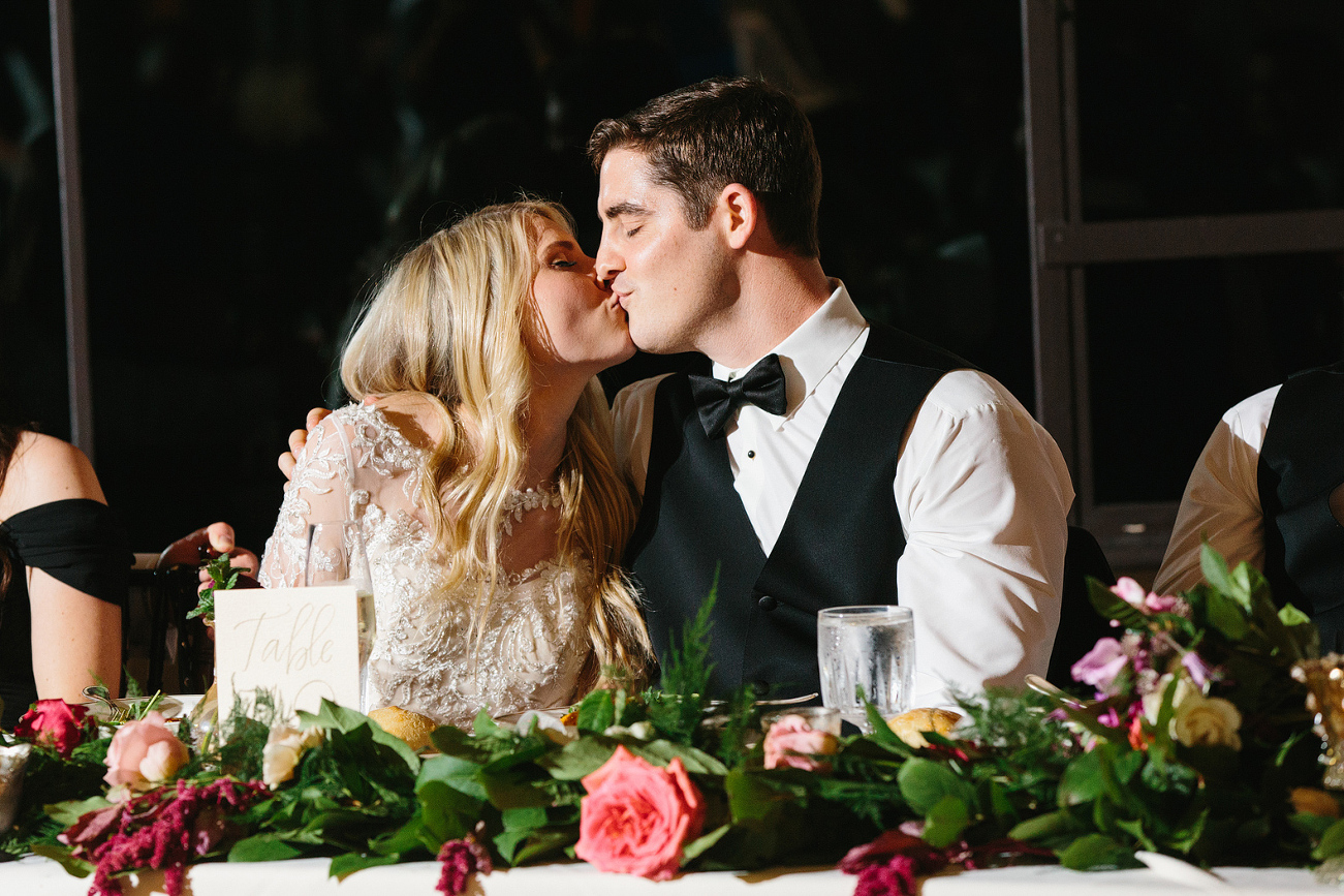 The bride and groom sitting at the head table. 