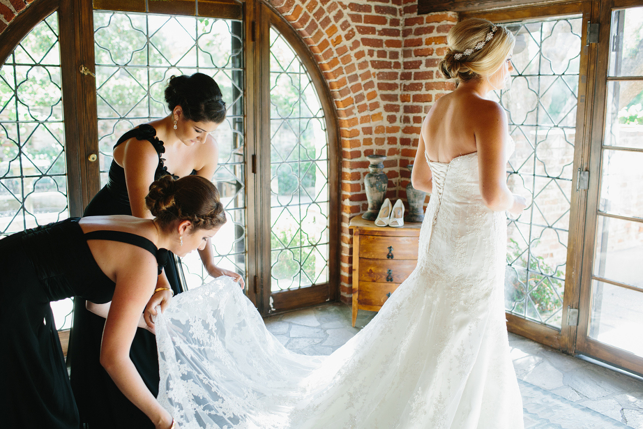 The bridesmaids fixing the bride