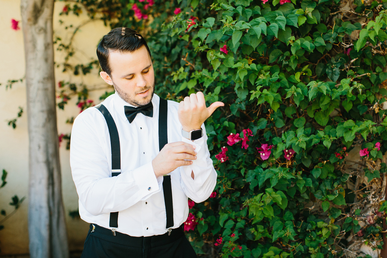 Cameron adjusting his cufflinks. 