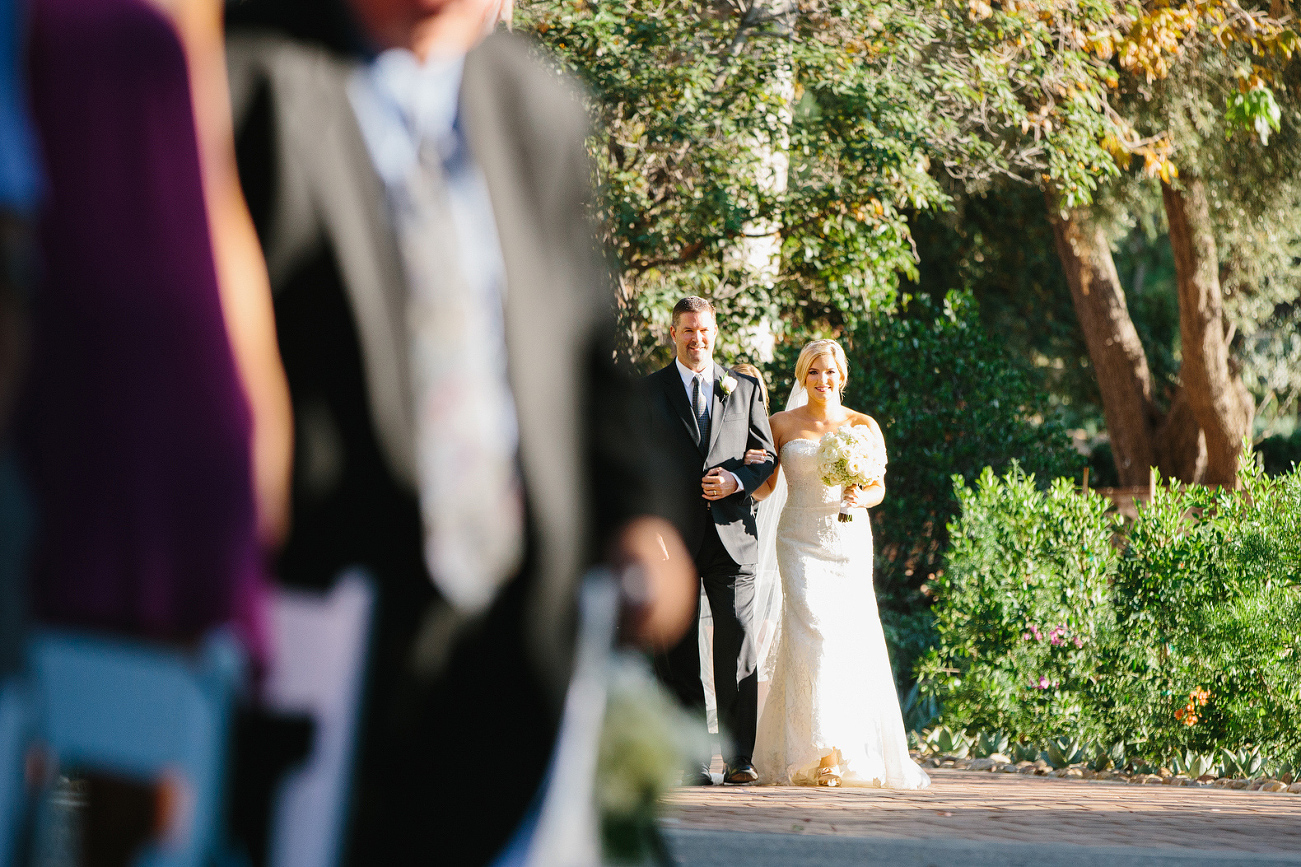 The bride walking down the aisle with her dad. 