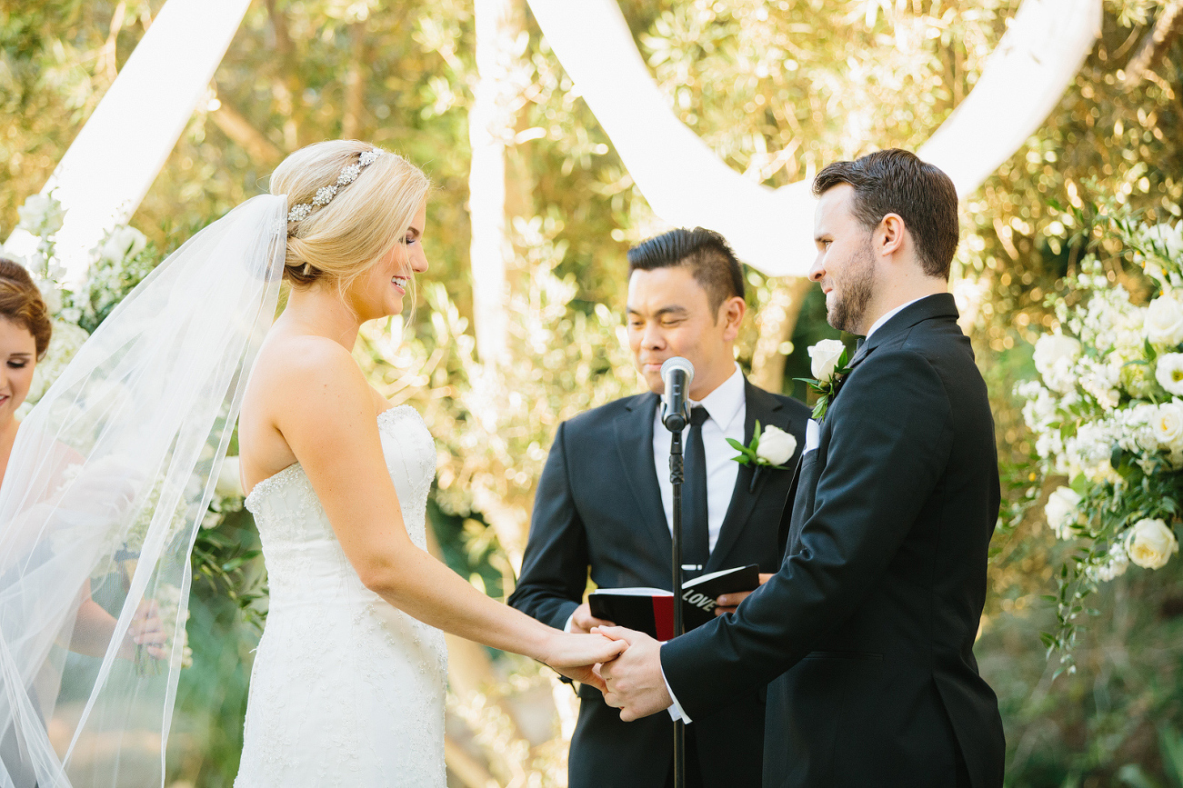 The bride and groom holding hands. 