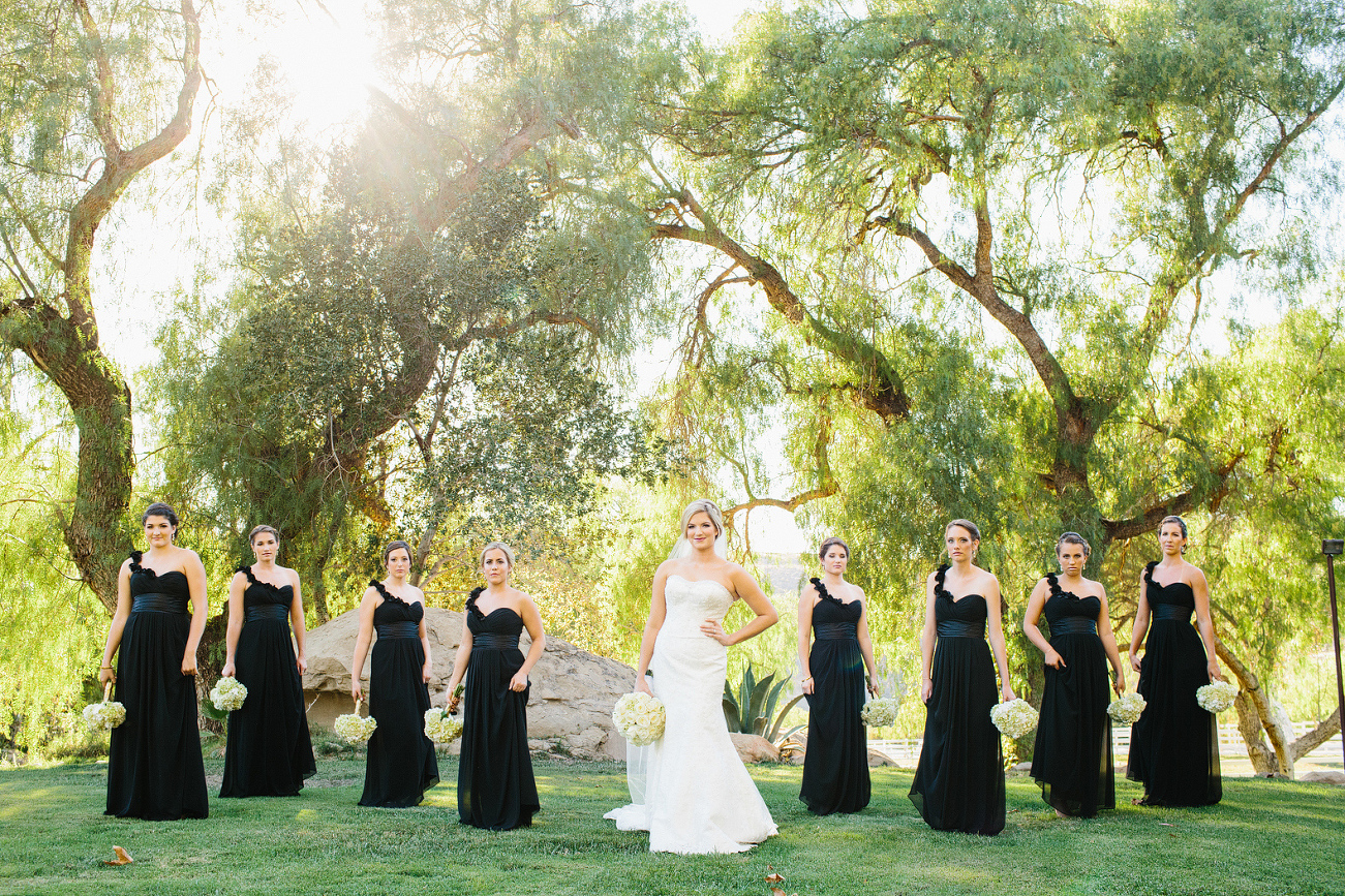 Morgan and her bridesmaids in front of large trees. 