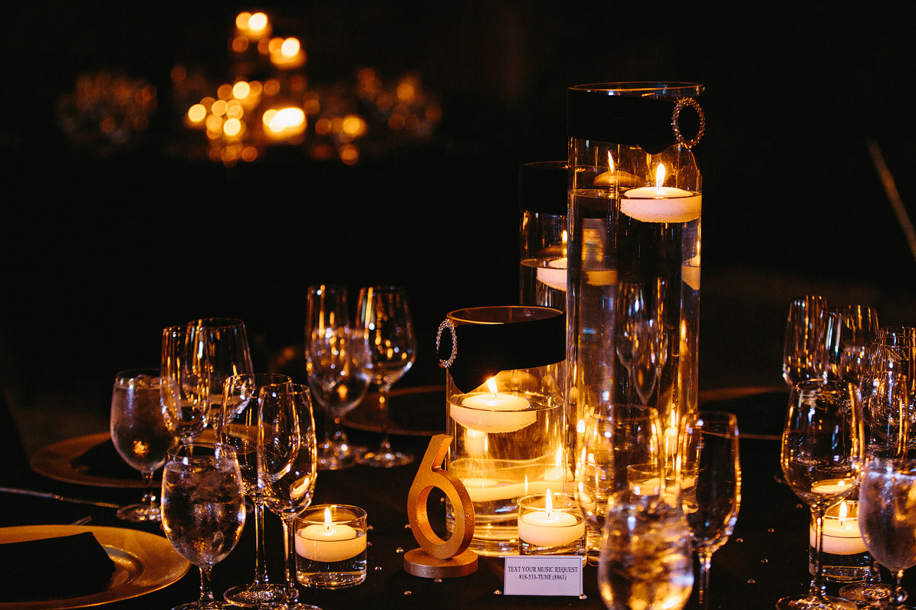 The black and gold candlelit centerpieces. 
