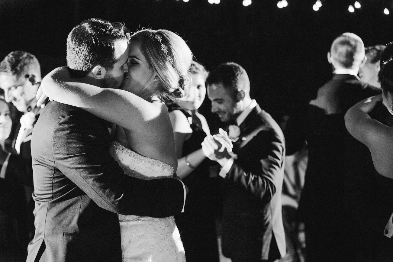 The couple surrounded by their bridal party dancing. 