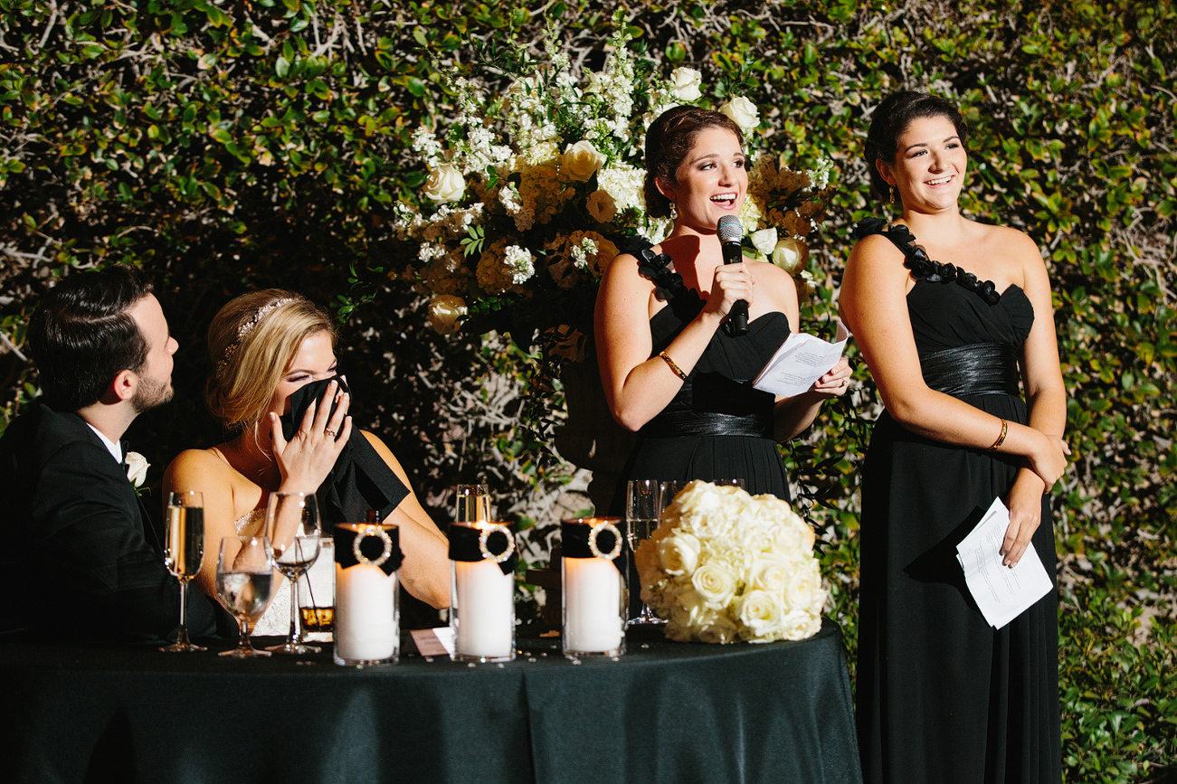 The bride laughing during the maid of honor toast. 