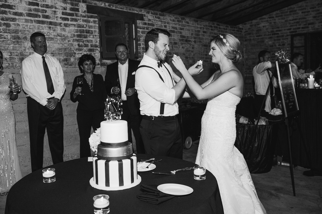 Morgan and Cameron feeding each other cake. 