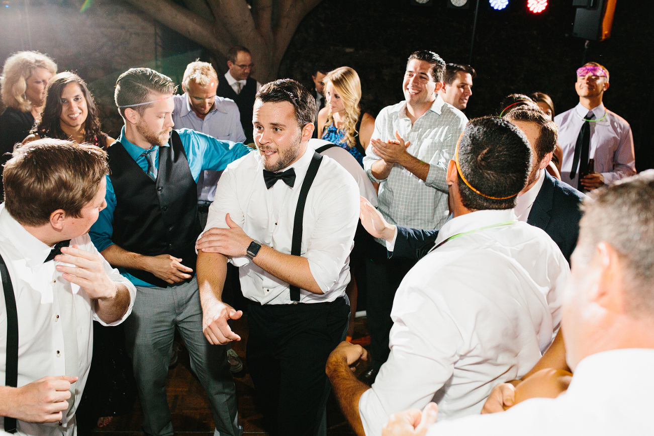 The groom dancing with his friends. 
