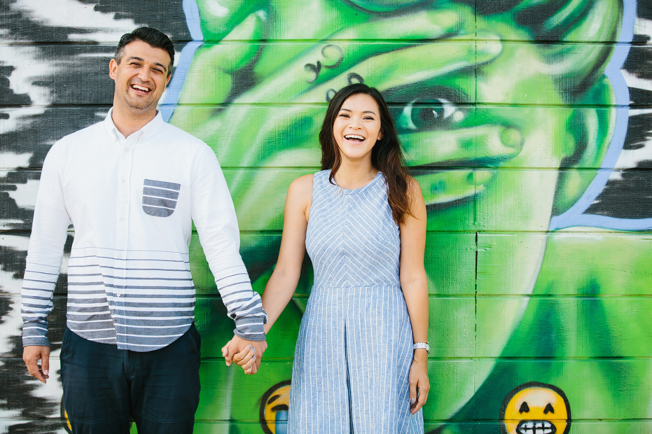 Maily and Hajime in front of a mural. 