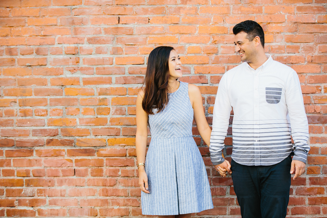 Maily and Hajime in front of a brick wall. 