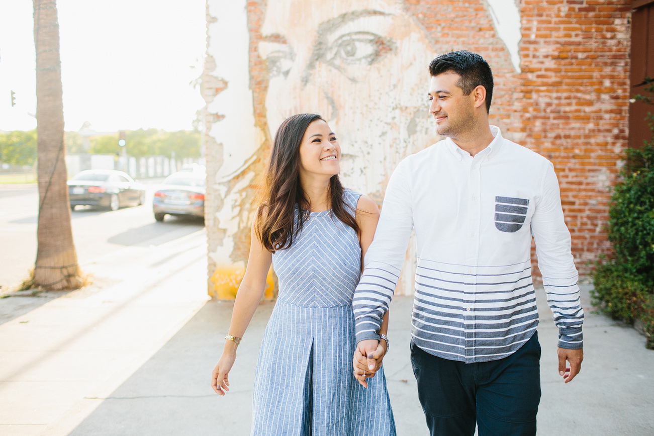 Maily and Hajime walking in front of a mural. 