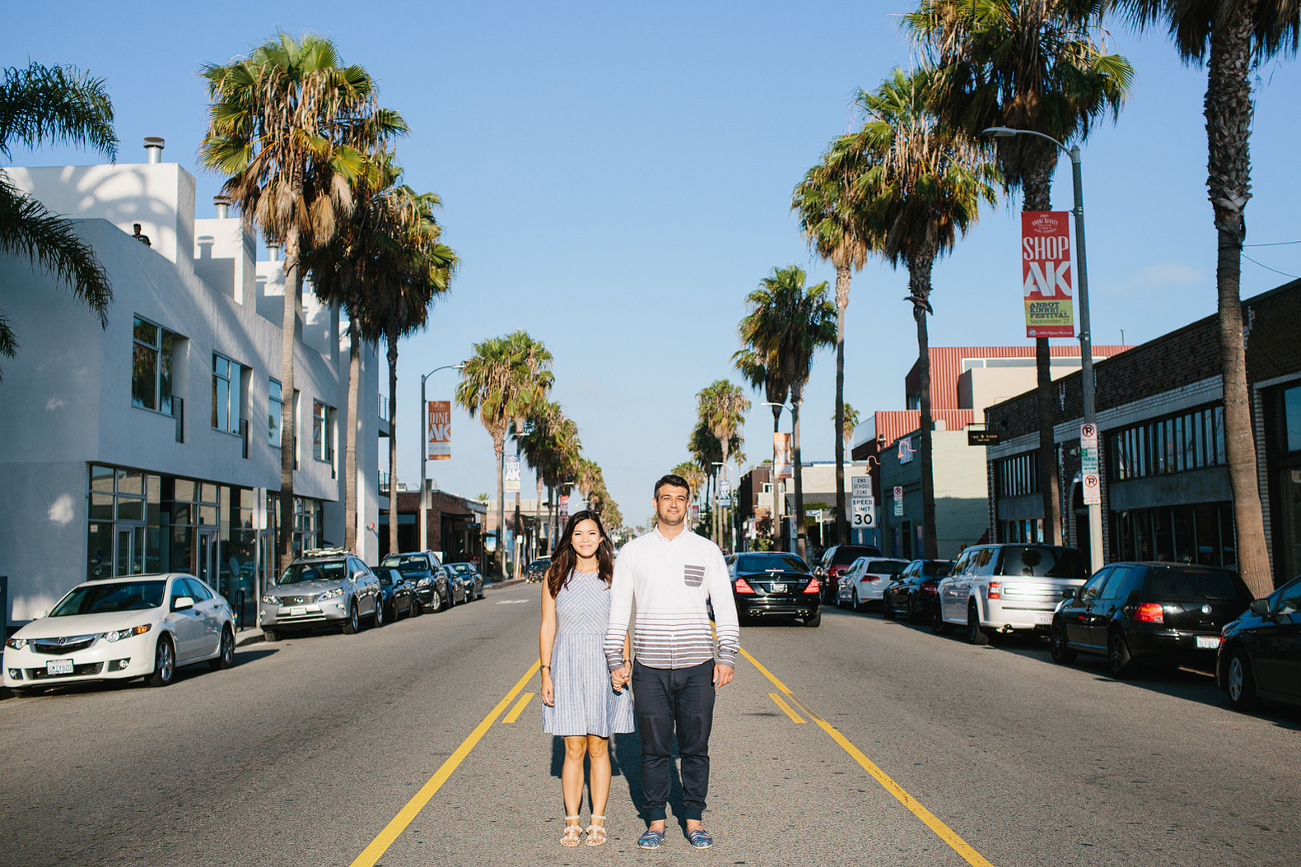 The couple standing in the middle of the street. 