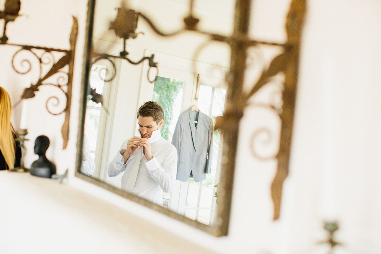 The groom getting dressed. 