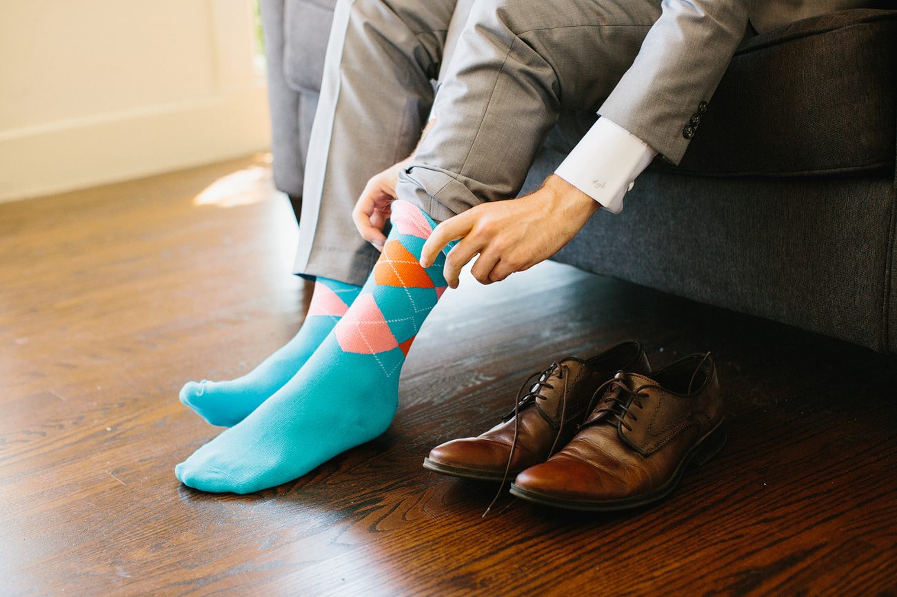 The groom wore bright teal socks. 