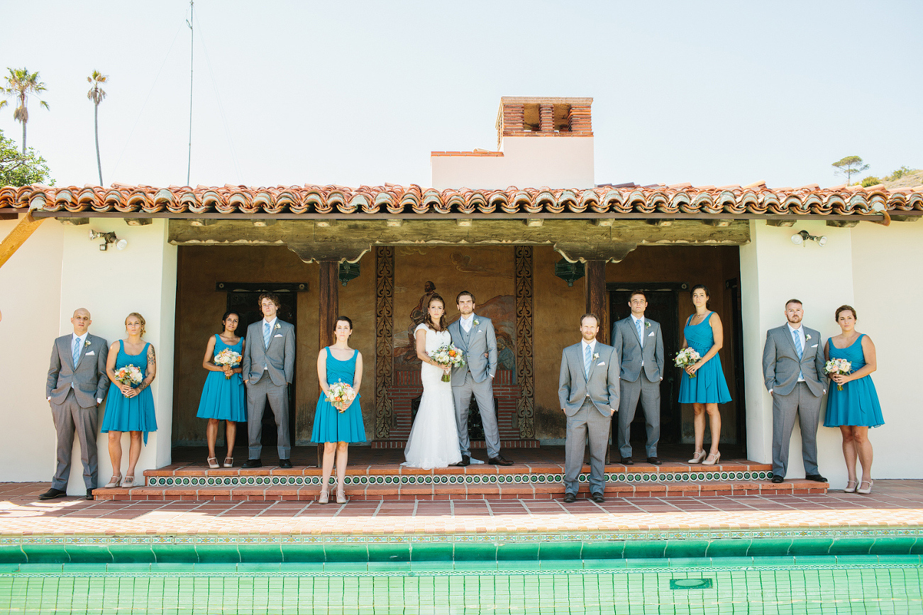 The full wedding party near the pool. 