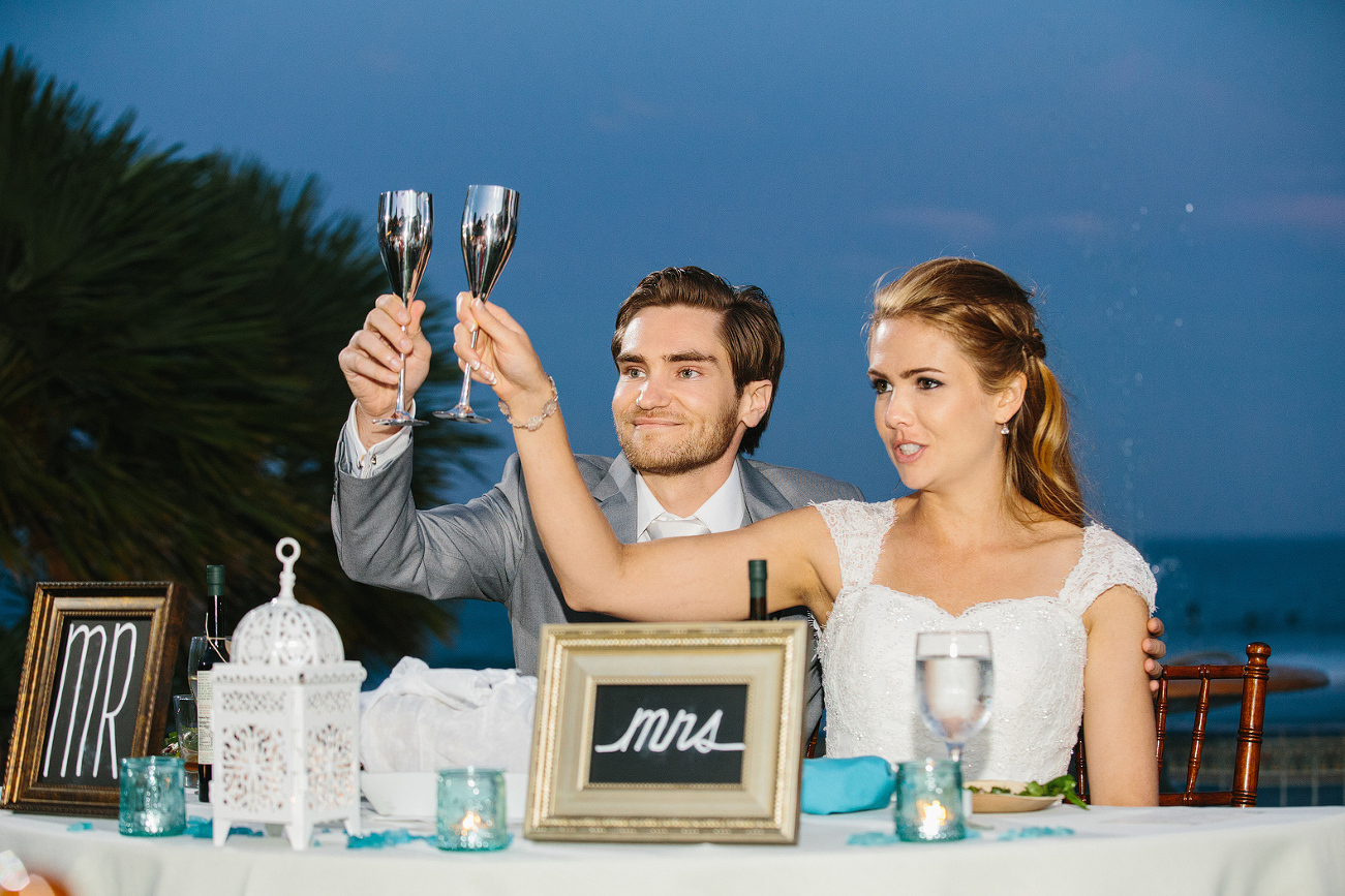 The bride and groom toasting with their guests. 