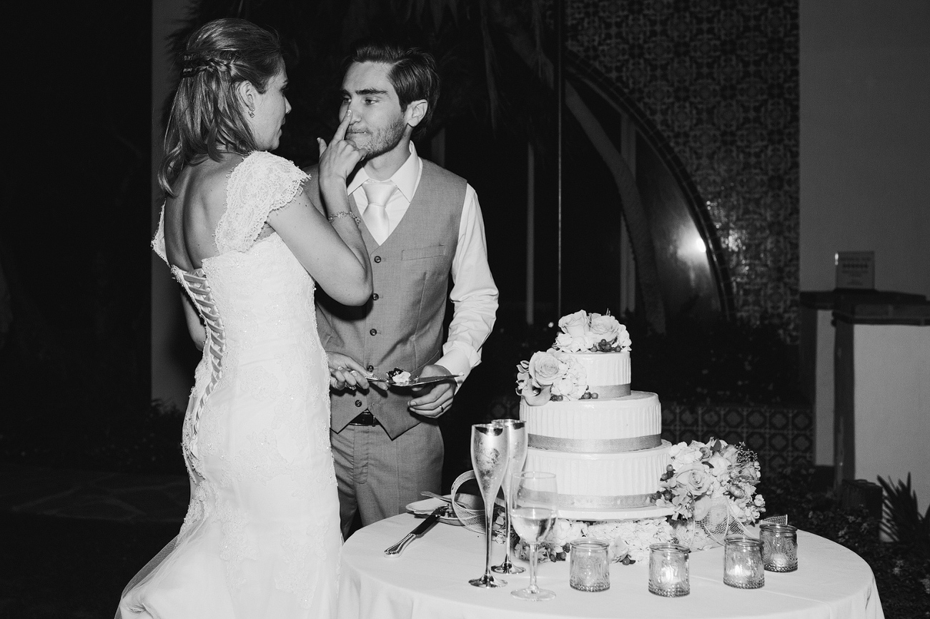 The bride putting frosting on the groom