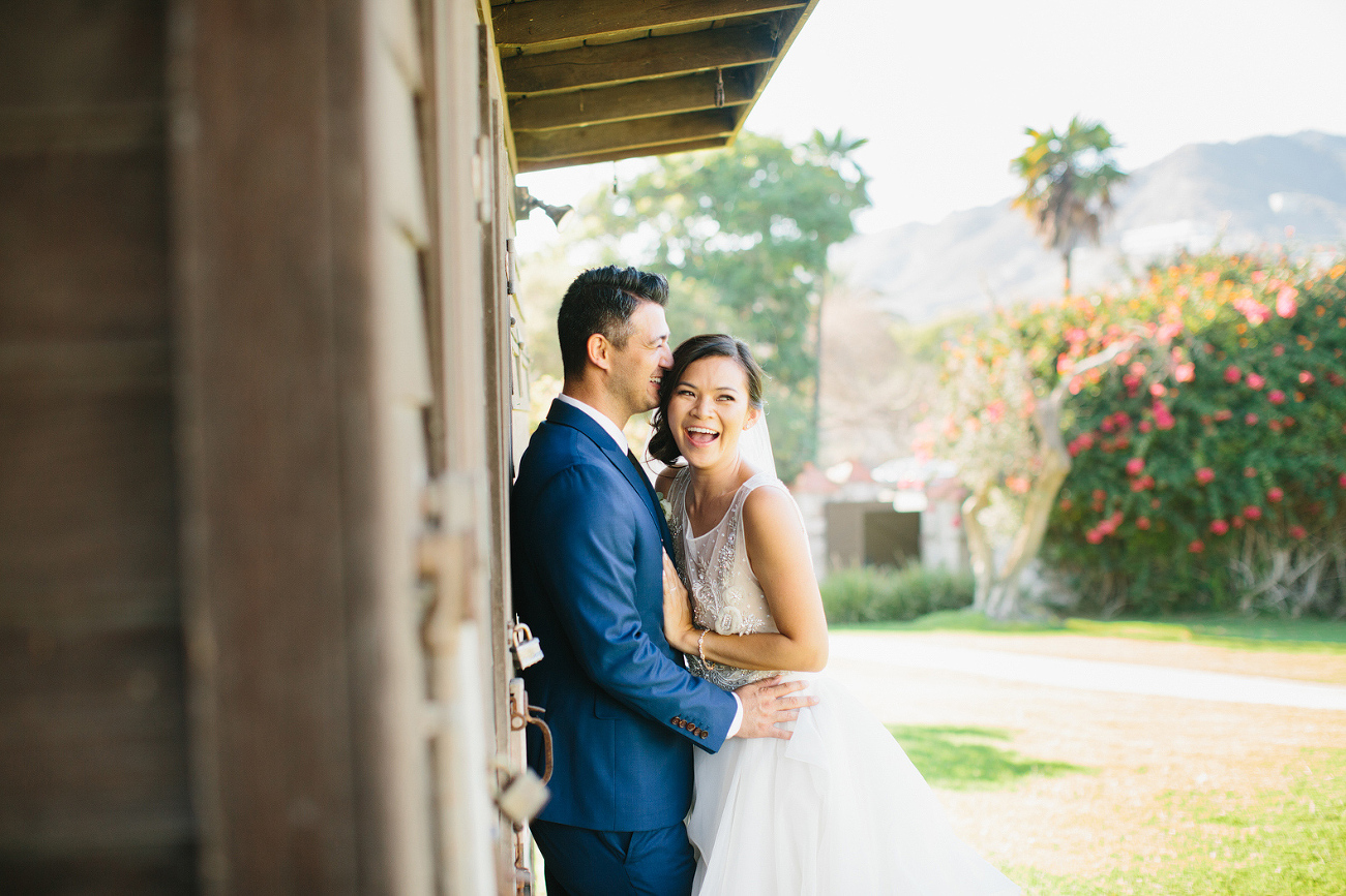 The couple near a wood structure. 