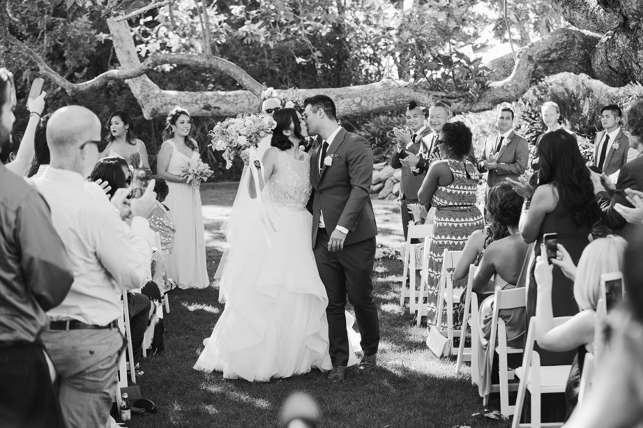 The couple kissing in the aisle. 