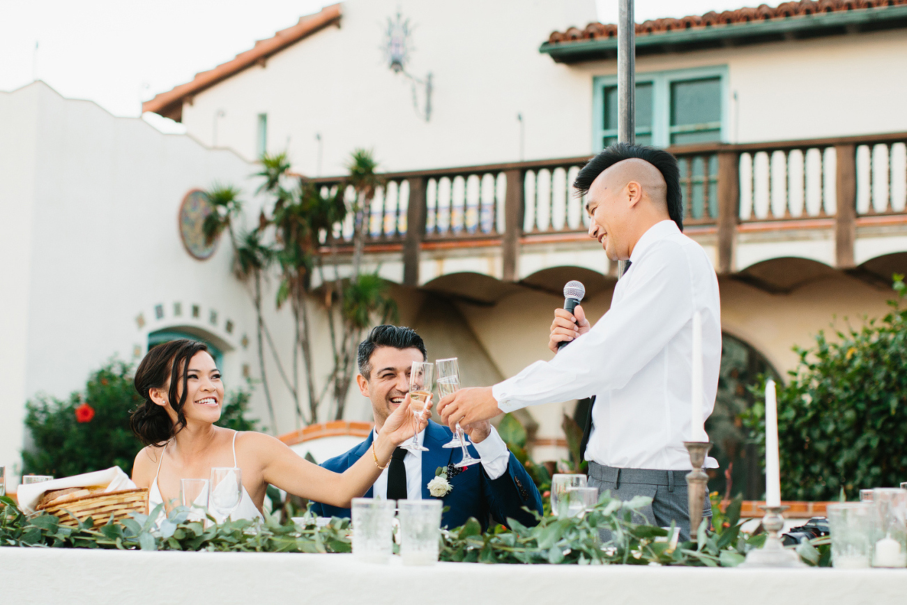 The couple toasting with the best man. 