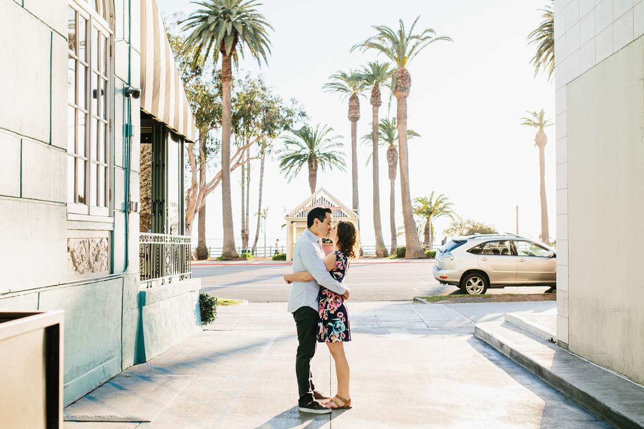 The couple centered between two buildings. 