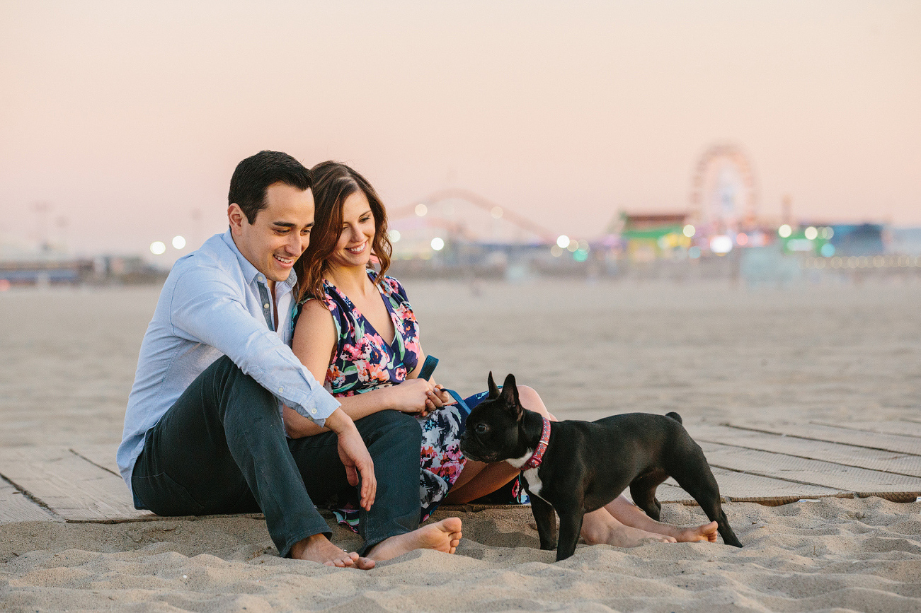 The couple looking at their dog. 