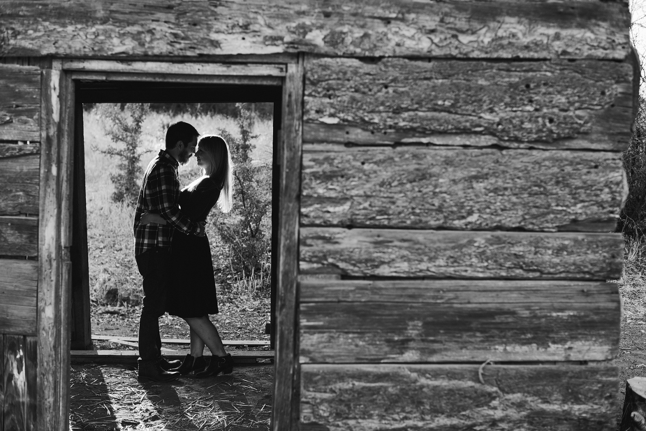 A gorgeous photo of the couple in the wooden structure. 