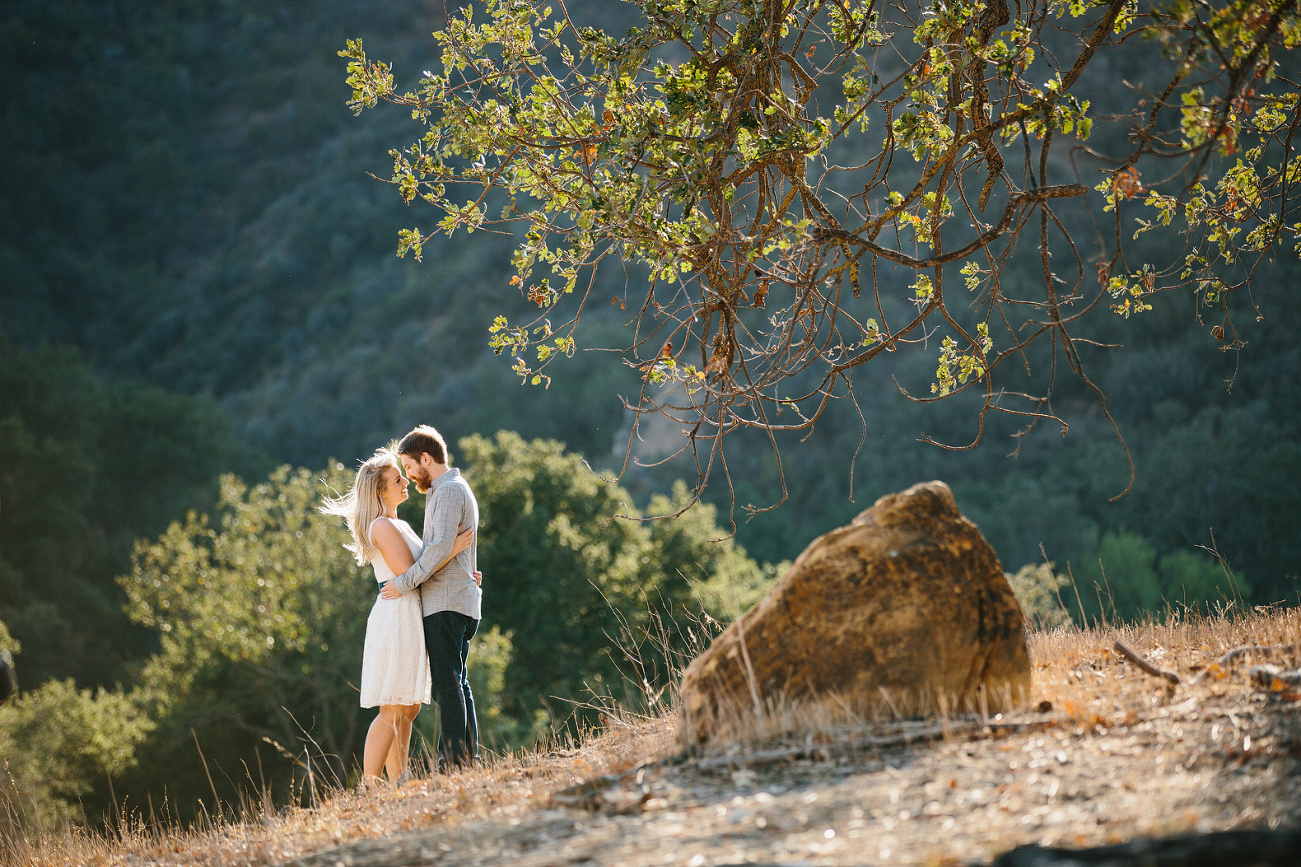 The couple standing off in the distance. 