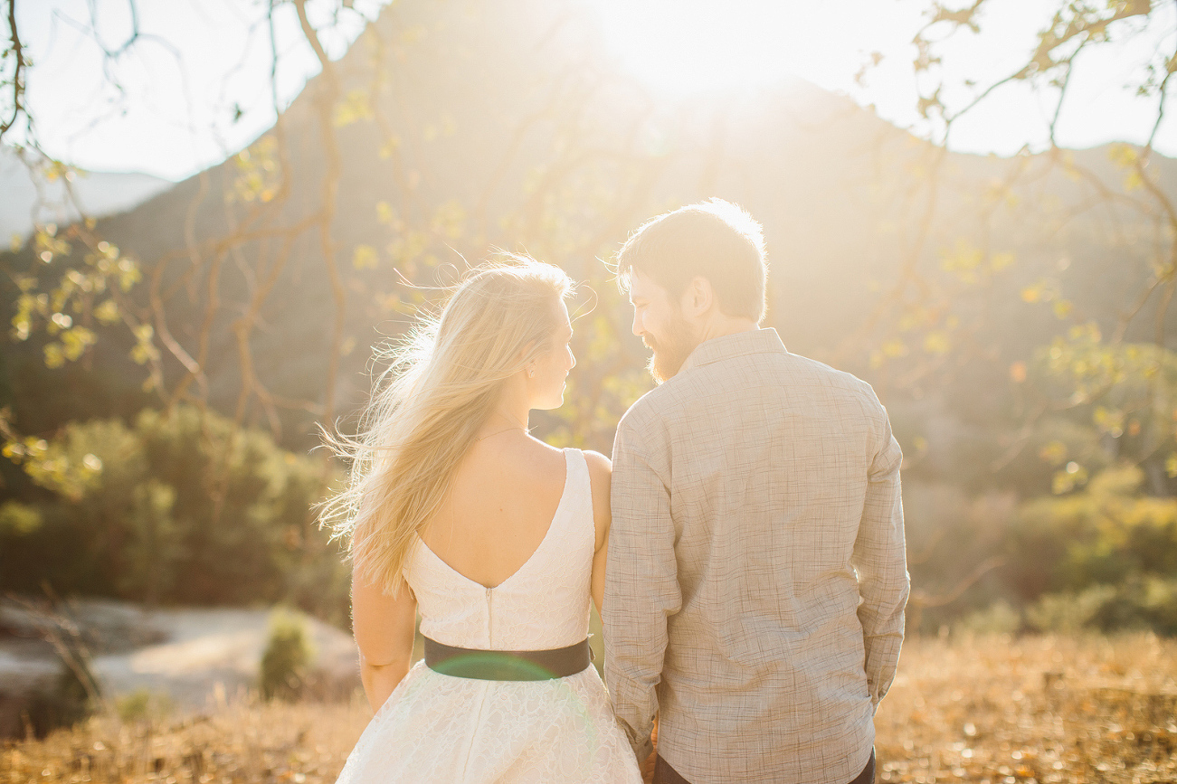 A beautiful bright photo of the couple looking out. 