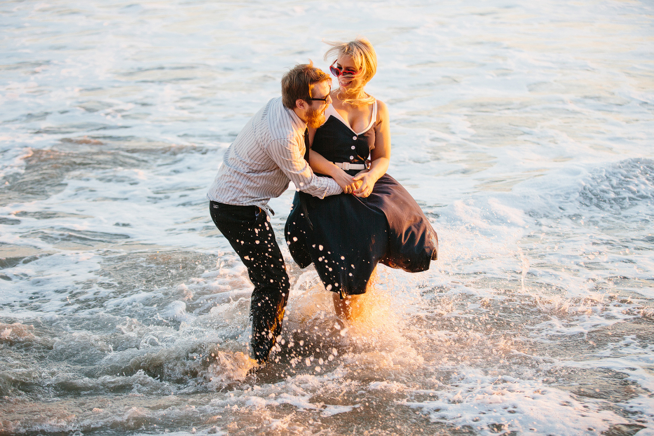 The couple splashing in the beach. 