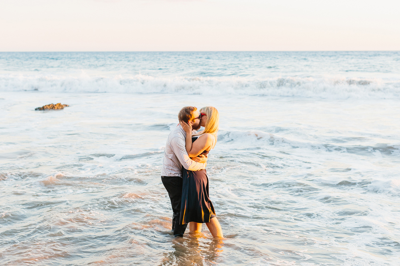 Lindsay and Josh standing in the ocean. 