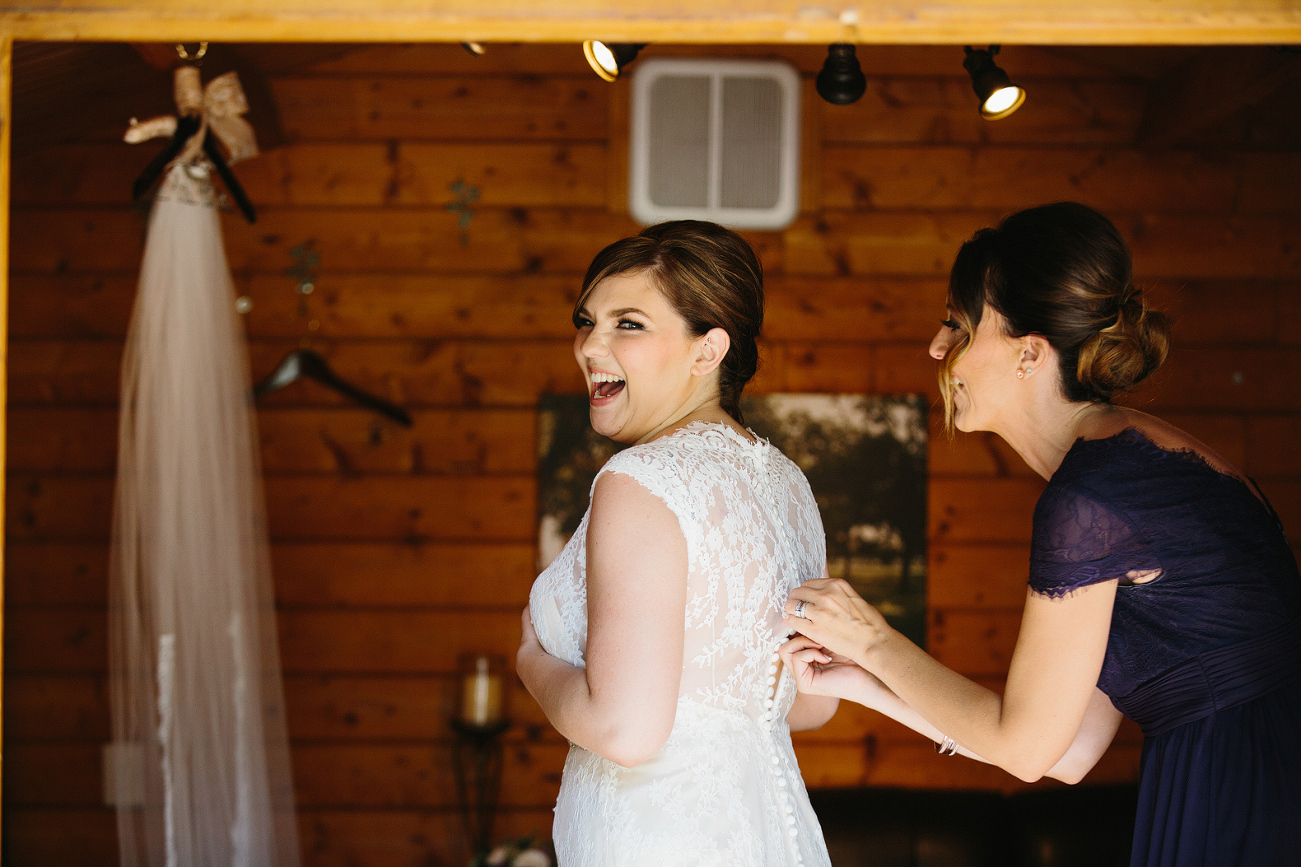 The bride getting in her dress. 